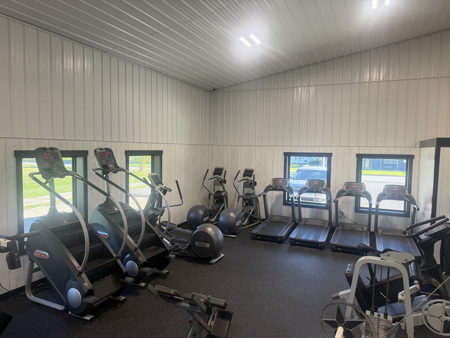 Cardio machines by the gym windows